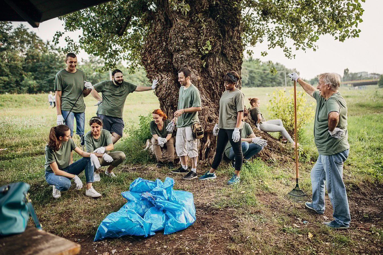 Enviromental volunteers resting after cleaning nature from garbage